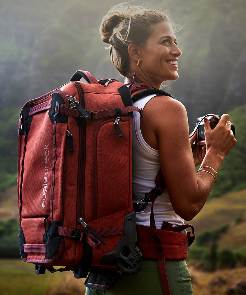 Close up of a woman in Hawaii wearing a red Gear Warrior Convertible Carry-On