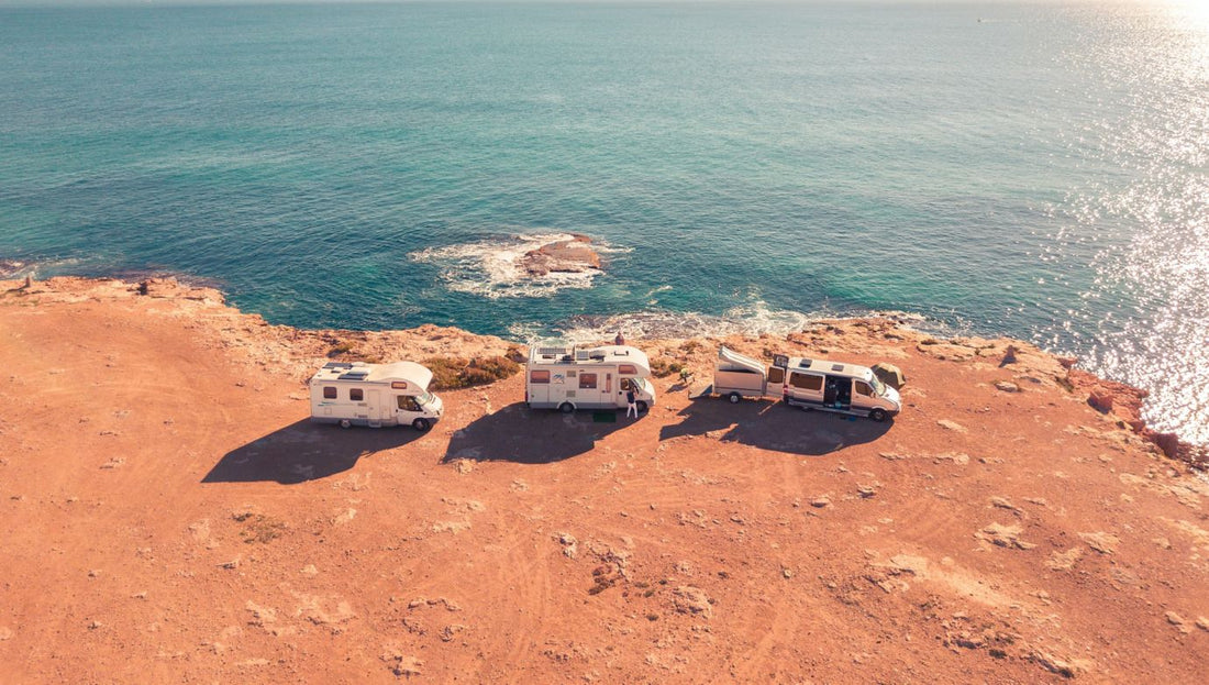 three RVs parked along coastal cliff