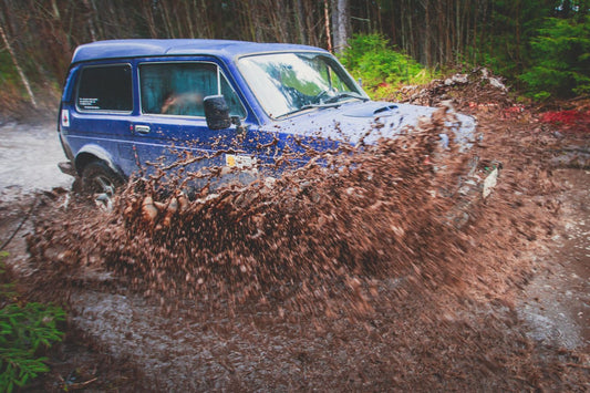 Suv offroad 4wd car rides through muddy puddle