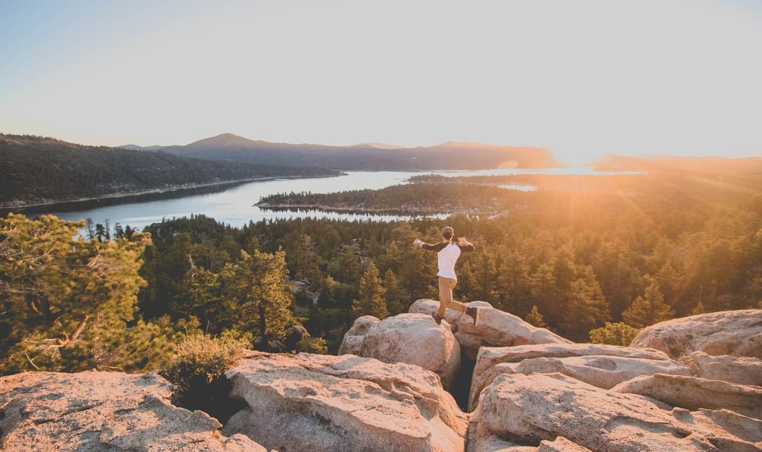 Man jumping over rocks on mountain