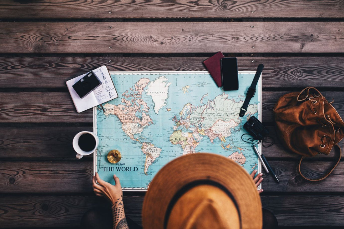 Young woman planning vacation using world map