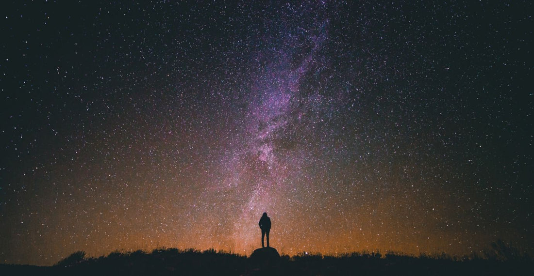 traveler looking out into starry sky